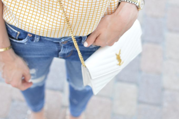 distressed boyfriend jeans and white cross body bag