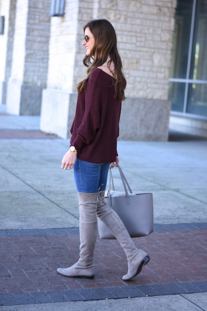 burgundy off the shoulder sweater, grey over the knee boots, grey tote bag