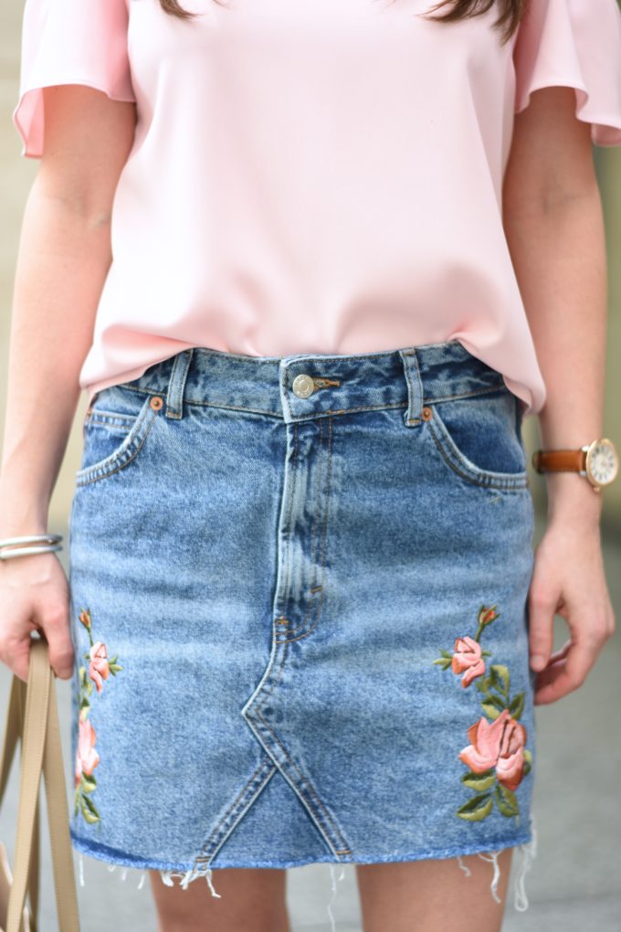 pink top, embroidered denim skirt