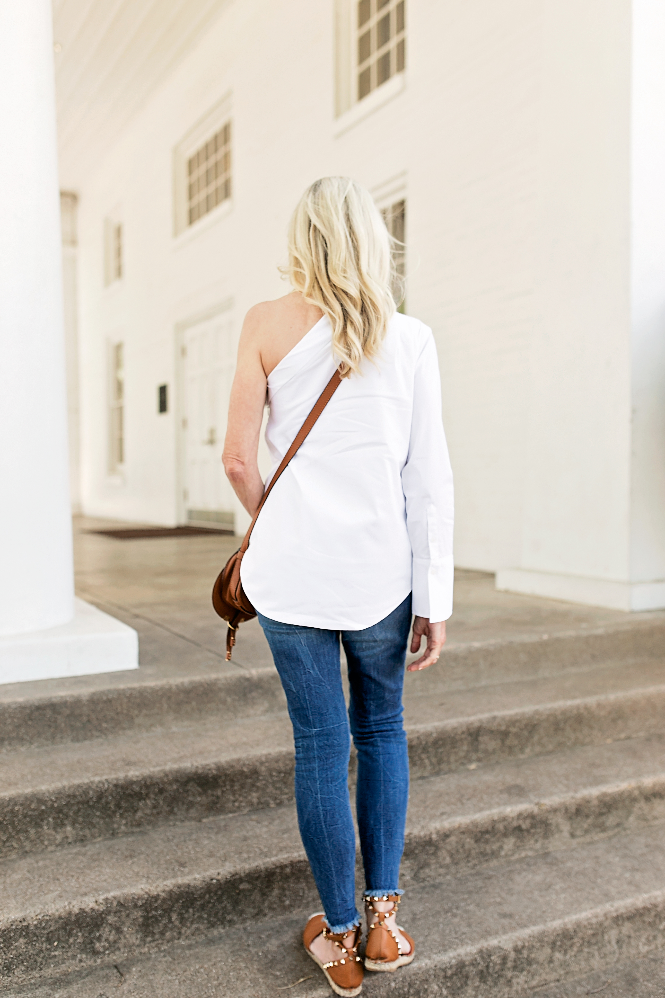 white one shoulder menswear inspired dress shirt brown espadrilles jeans