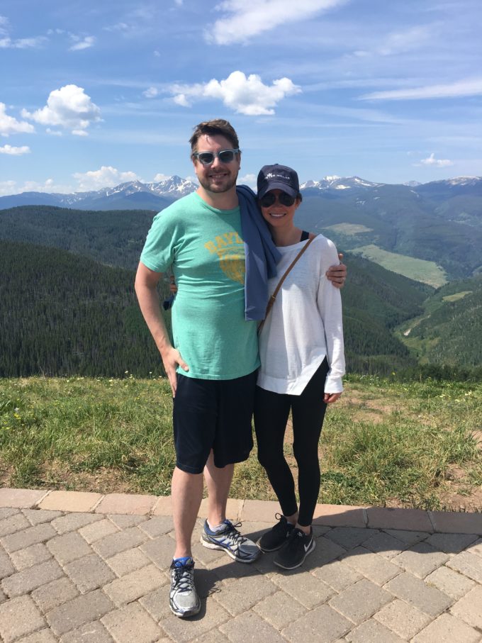 couple standing on the top of vail mountain