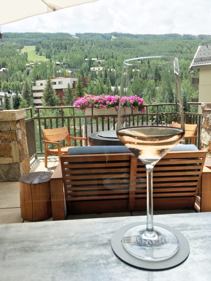 a glass of rose with view of vail mountain
