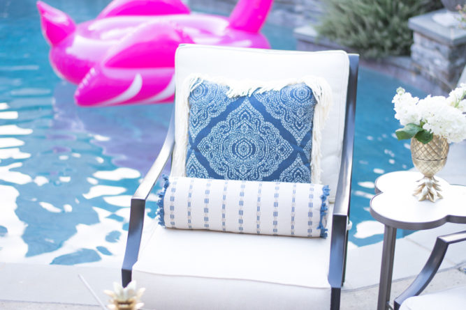 outdoor lounge chair with blue print pillow