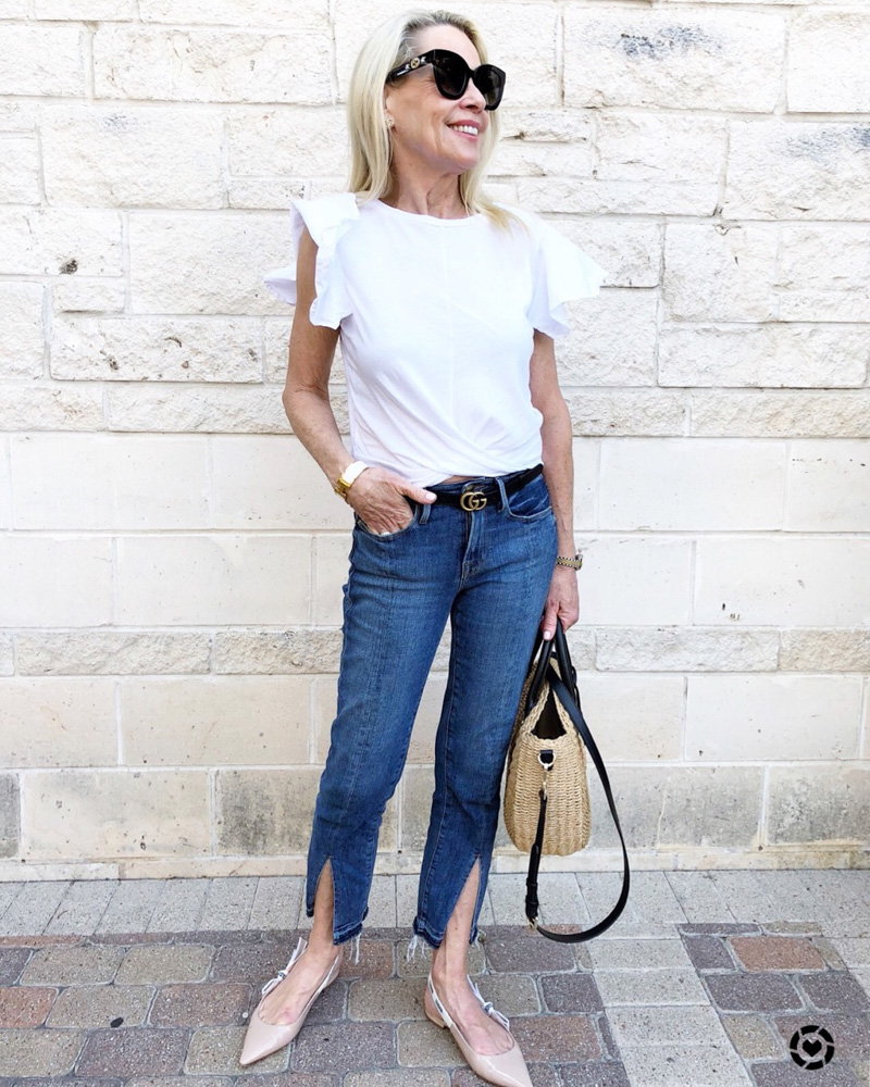 woman white tee jeans straw bag