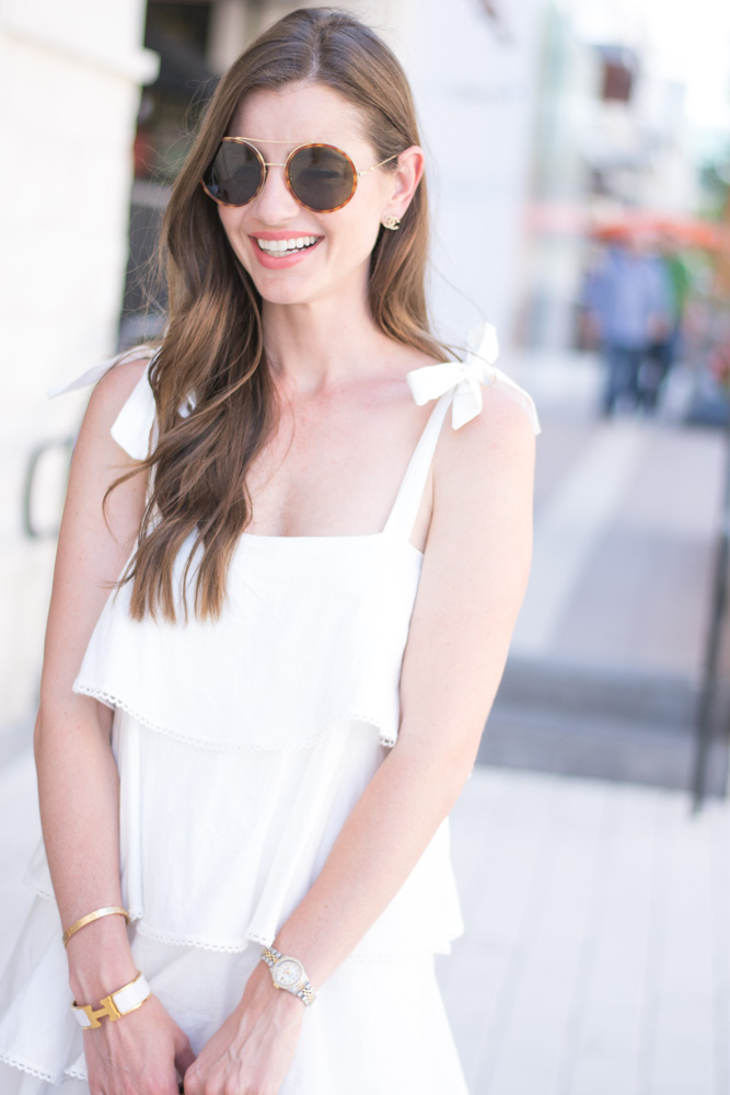round sunglasses white ruffle dress with tie shoulders
