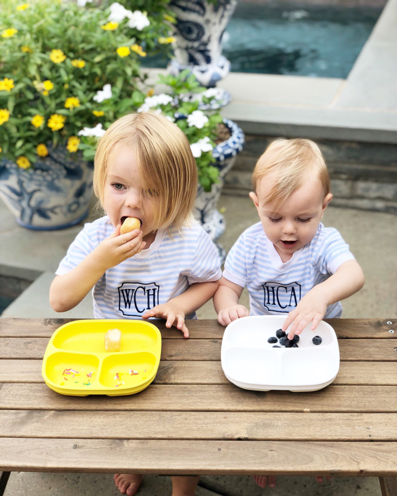 two boys eating at picnic table