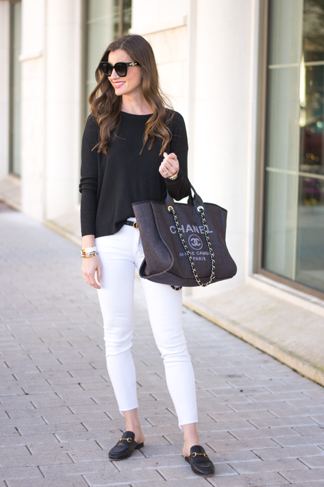 classic black sweater white jeans black tote bag