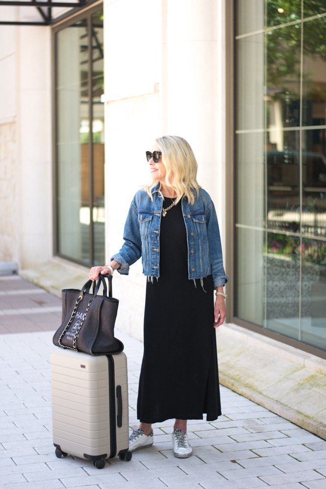 black maxi dress jean jacket chanel tote tan suitcase