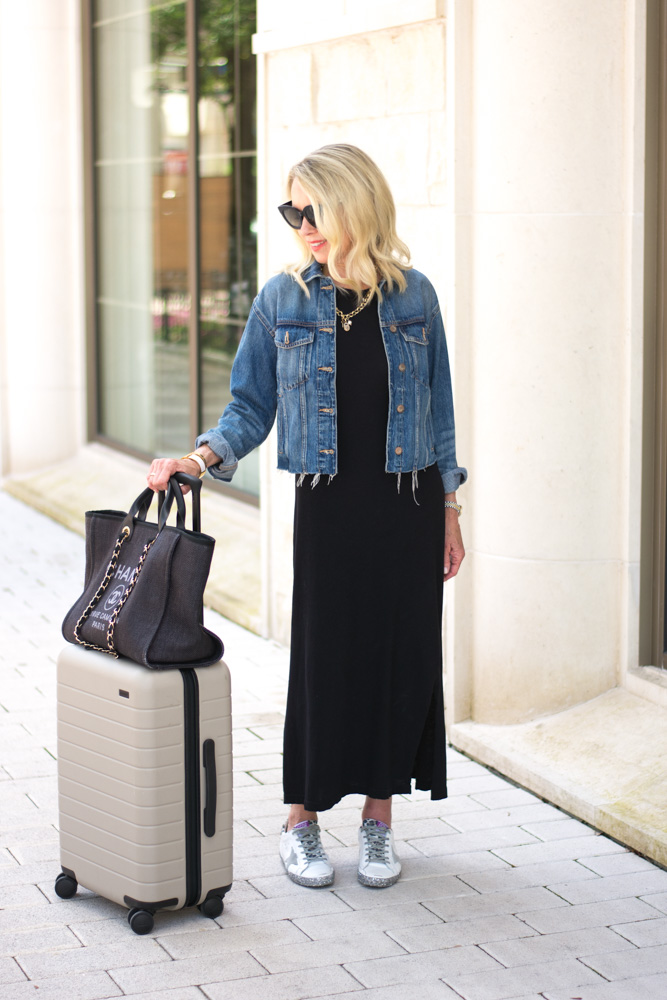 black dress with denim jacket and sneakers