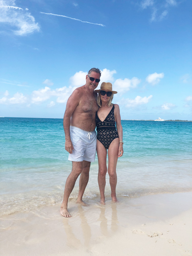 couple standing in the ocean at the beach