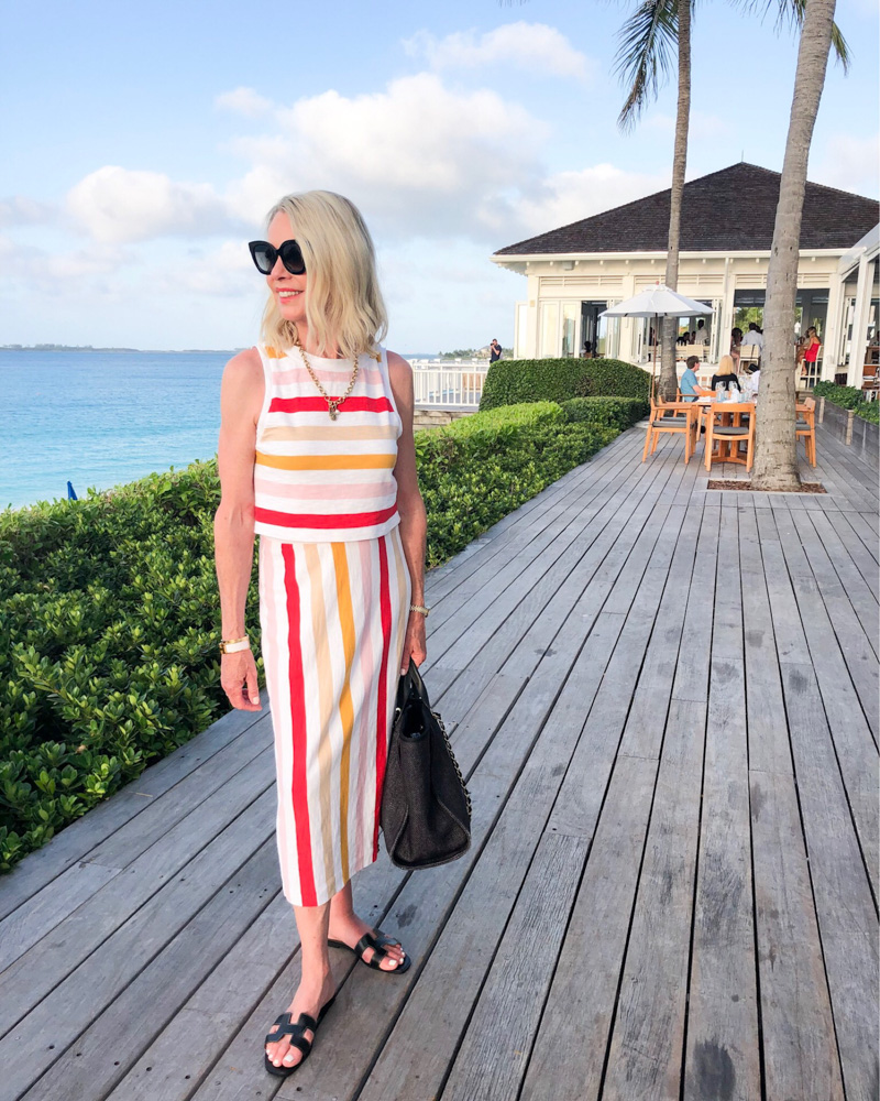 woman wearing striped two piece dress at beach