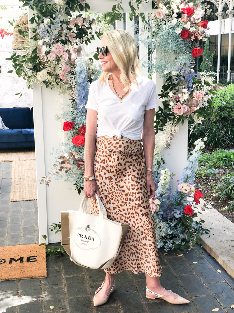 woman wearing leopard print skirt white tee