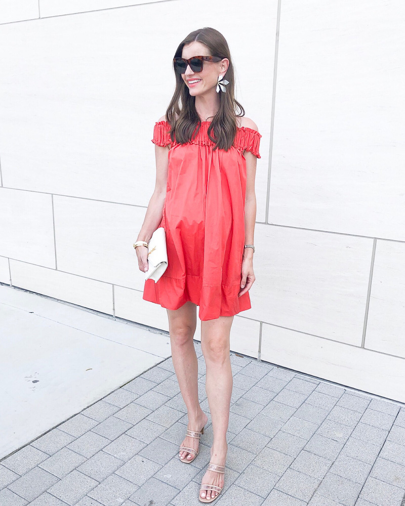 woman wearing coral maternity mini dress