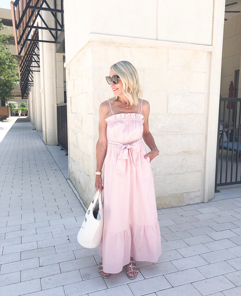 woman wearing pink white polka dot maxi dress