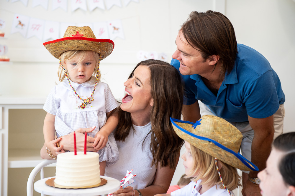 family singing happy birthday to toddler boy