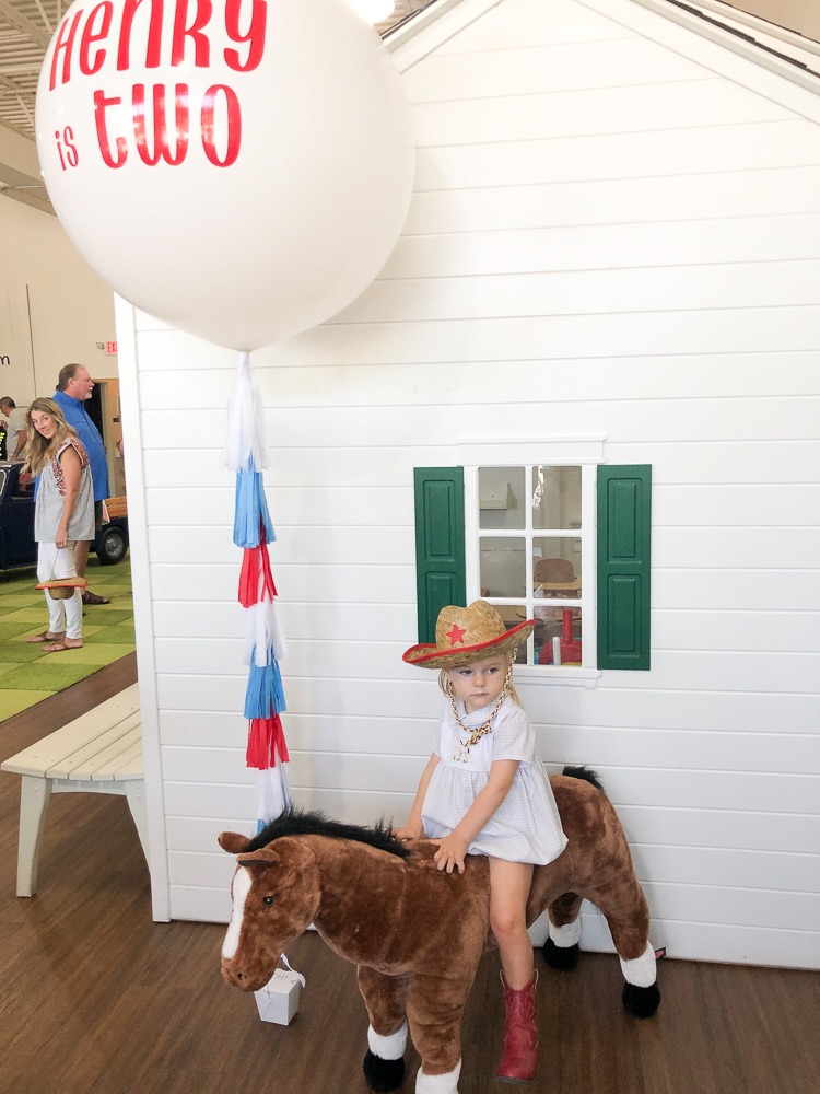 toddler boy at pony birthday party