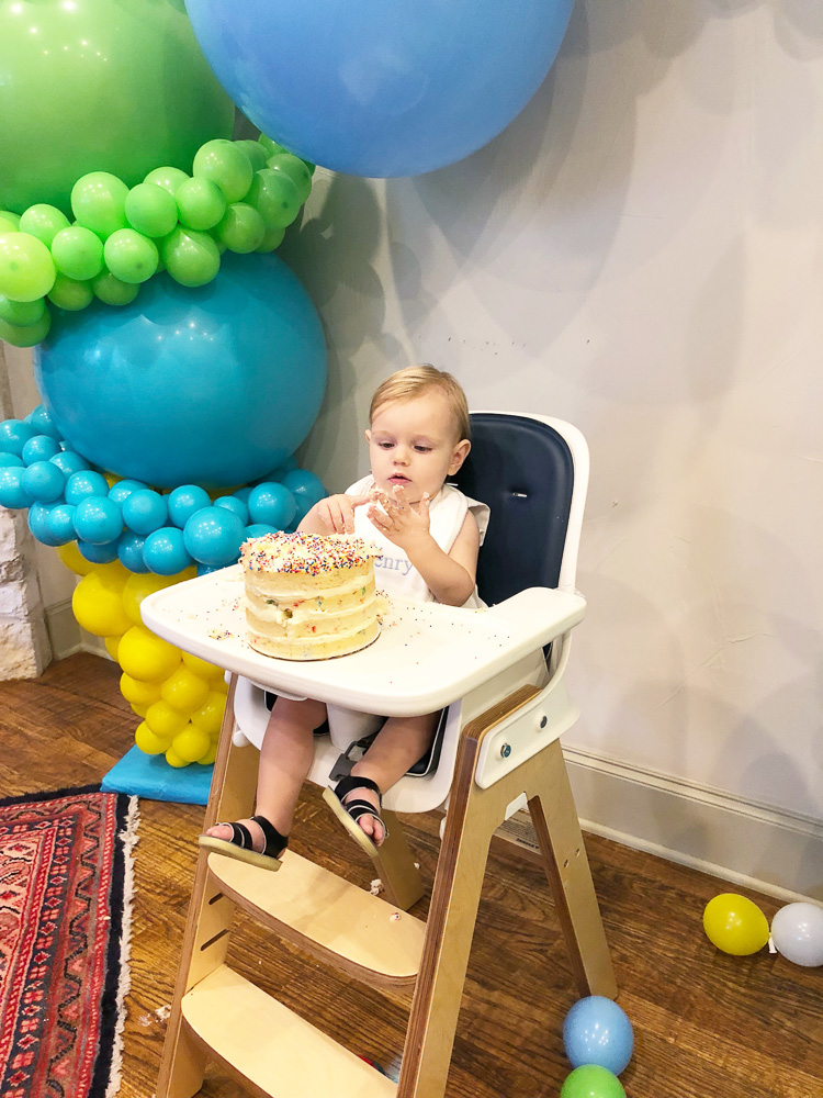 baby boy's first birthday eating cake