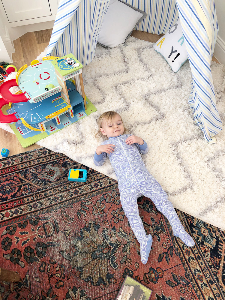 toddler boy laying on floor