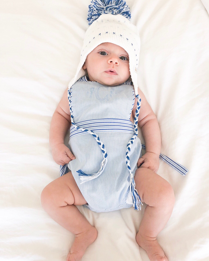 babyboy in bubble and knit pom pom hat