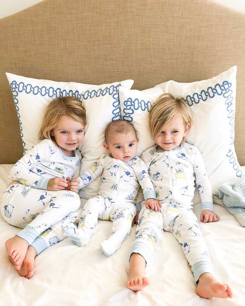 three brothers cuddling in bed