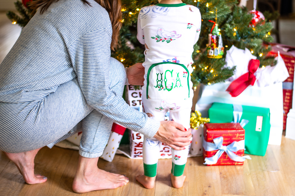 mom with toddler in front of christmas tree