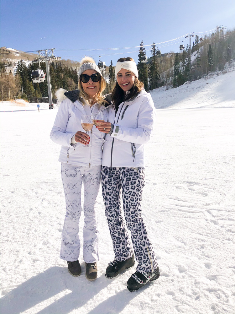 two women in the snow toasting with rosé