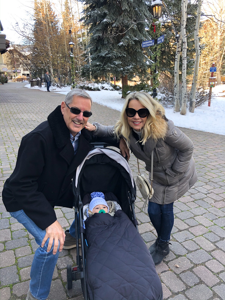 grandparents with baby bundled up in stroller