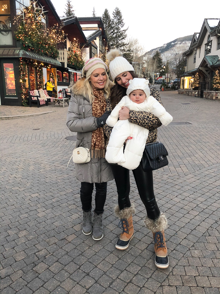 mom and grandmother with baby bundled up for winter