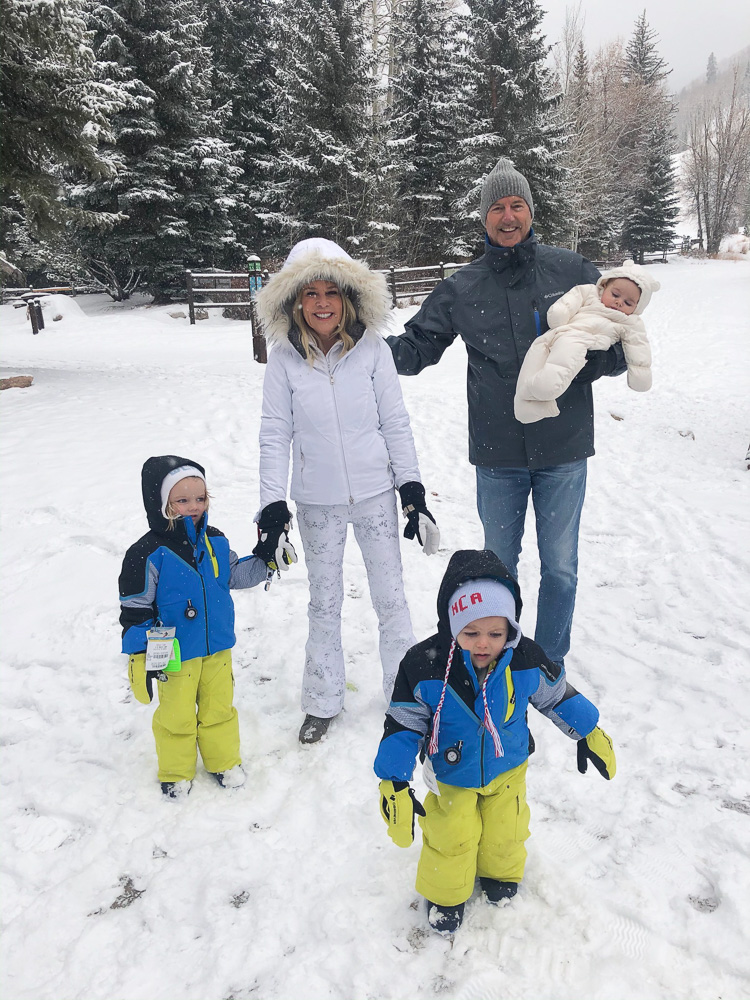 family playing in the snow
