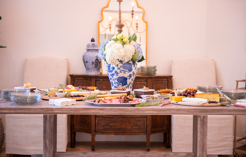 ding table with charcuterie and large floral arrangement