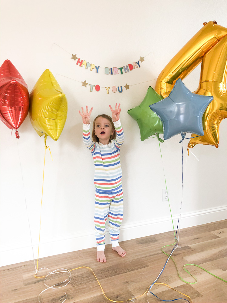 boy in striped pajamas with balloons