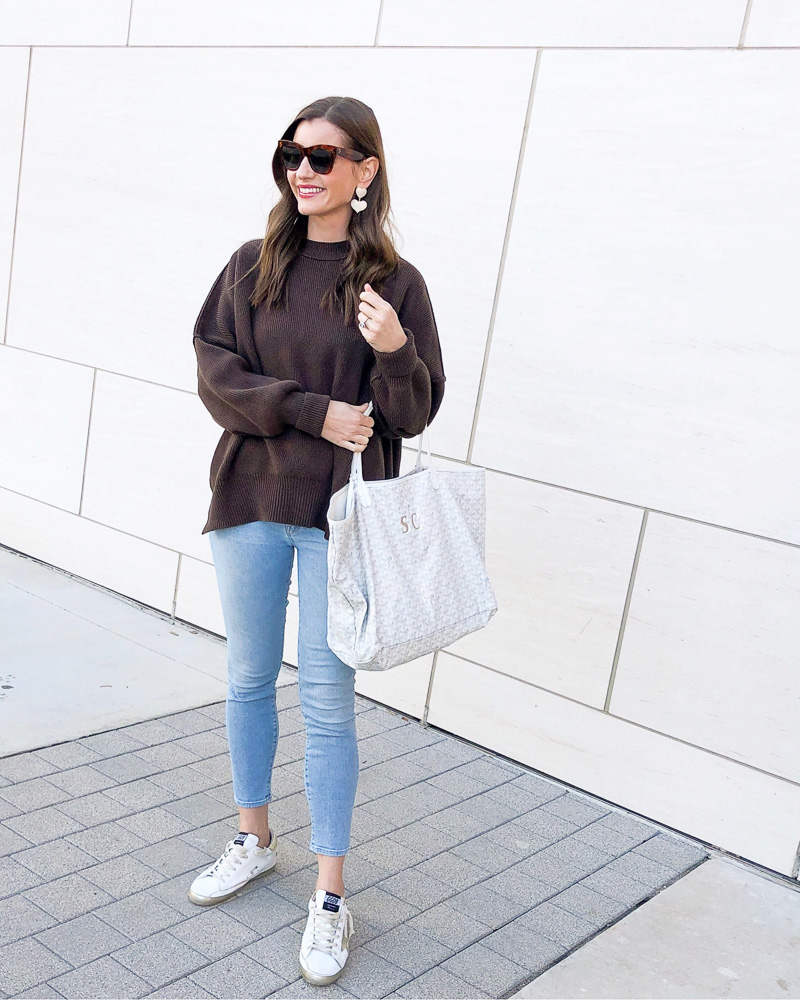 brown sweater light blue jeans golden goose sneakers white tote bag