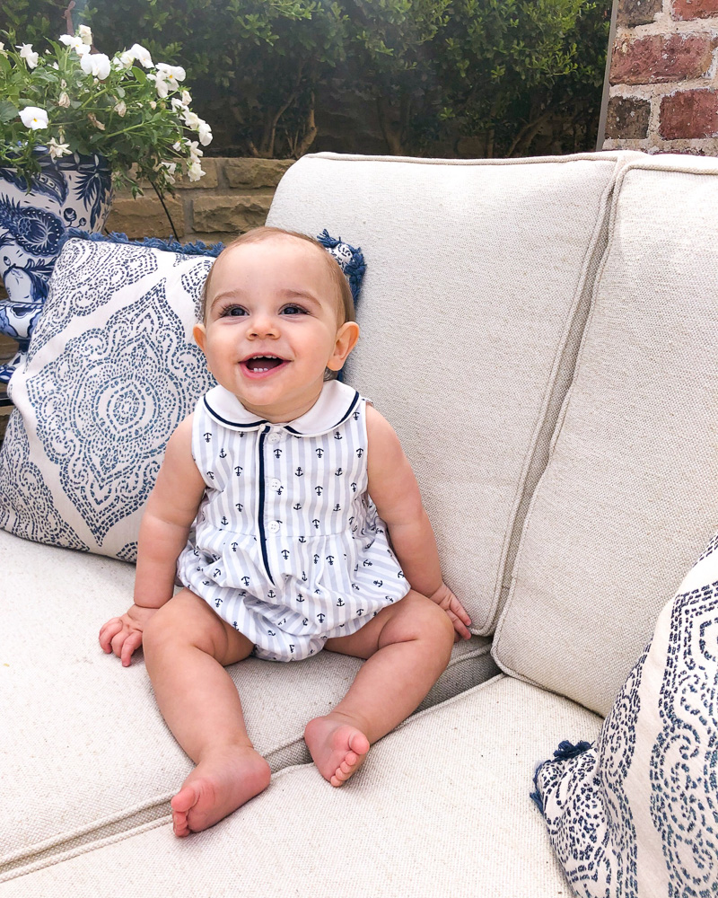 baby laughing sitting outside on settee