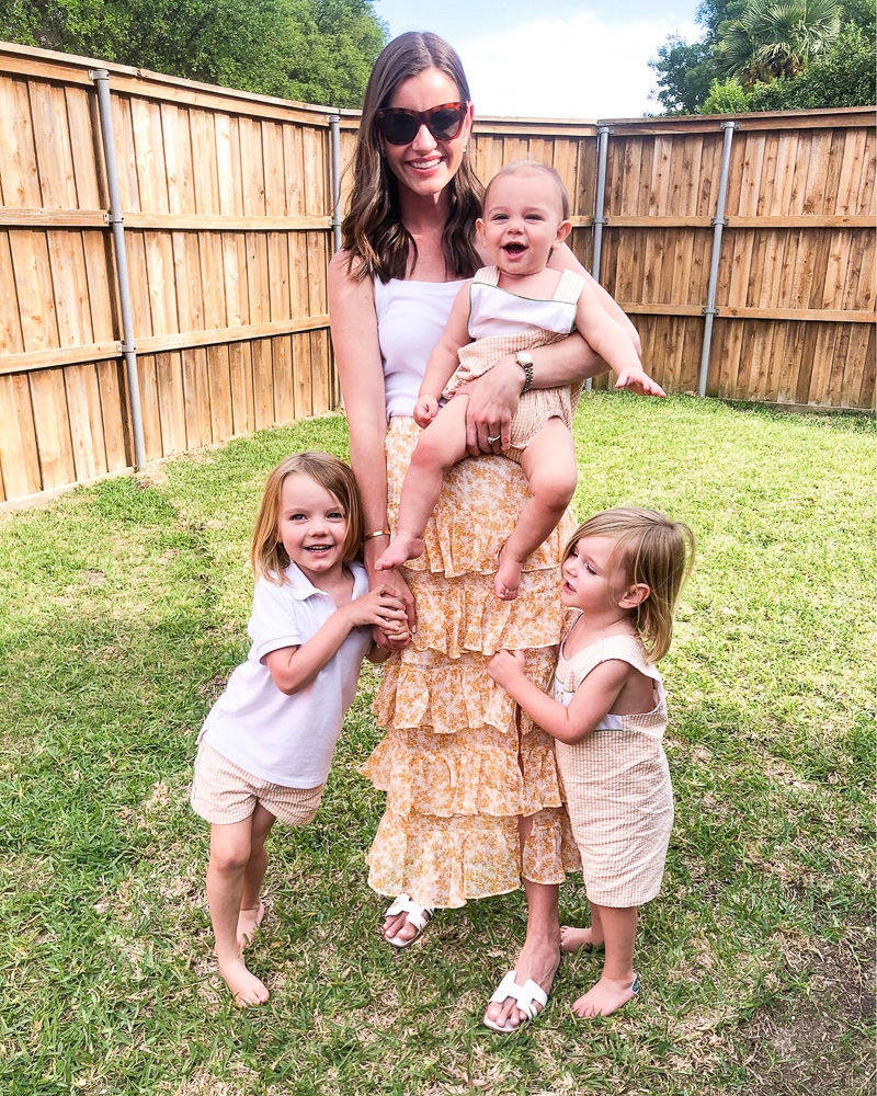 mom with three little boy in backyard