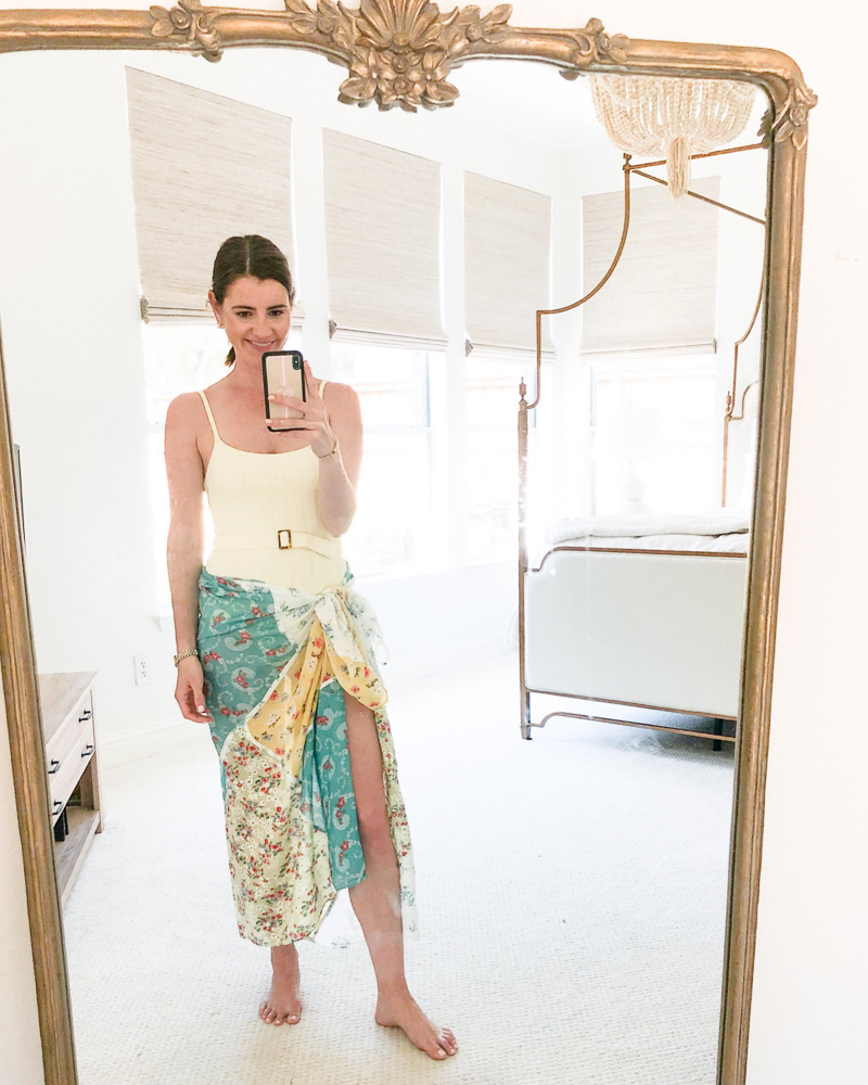 woman in yellow bathing suit and floral sarong