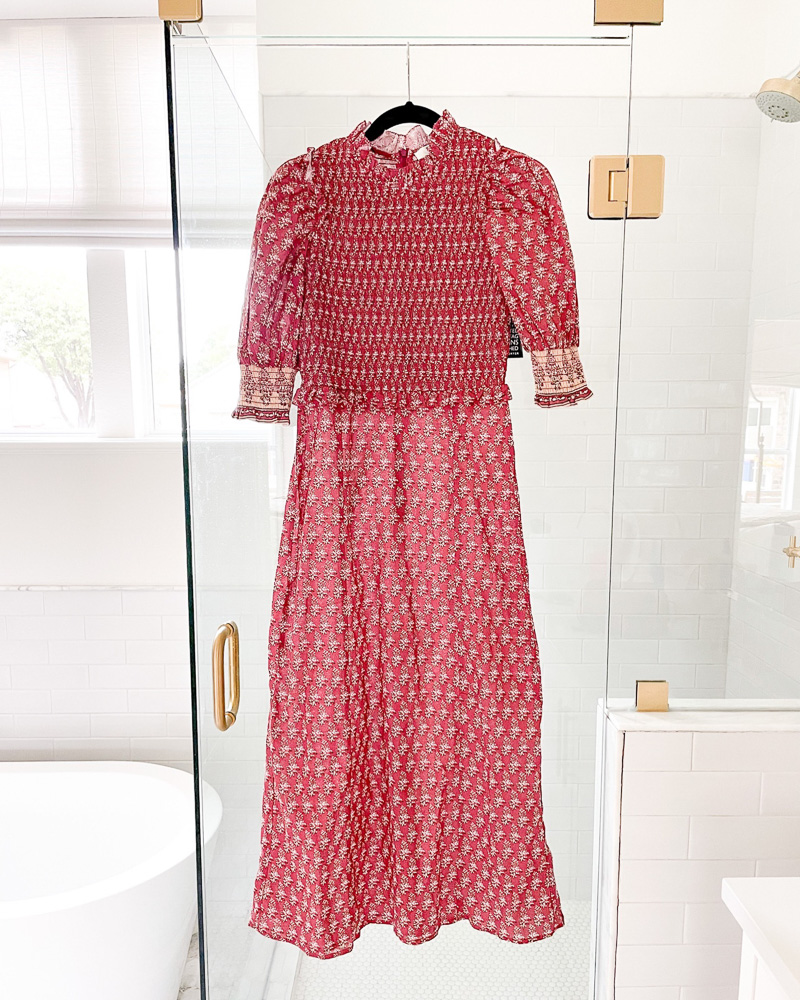 red printed maxi dress hanging in bathroom