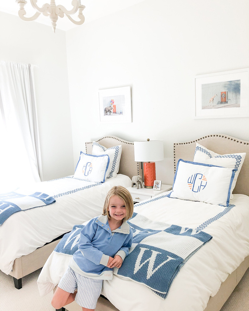 toddler boy leaning on bed