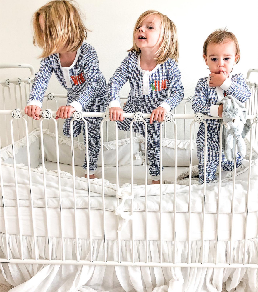 three brothers standing in crib