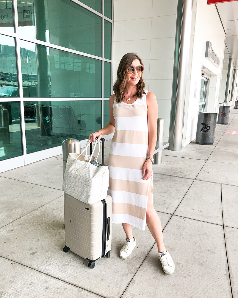 woman in striped midi dress at airport