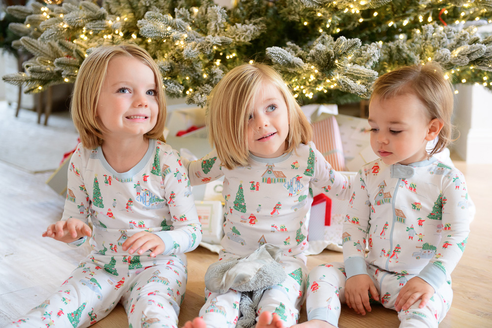 three toddler boys in front of christmas tree