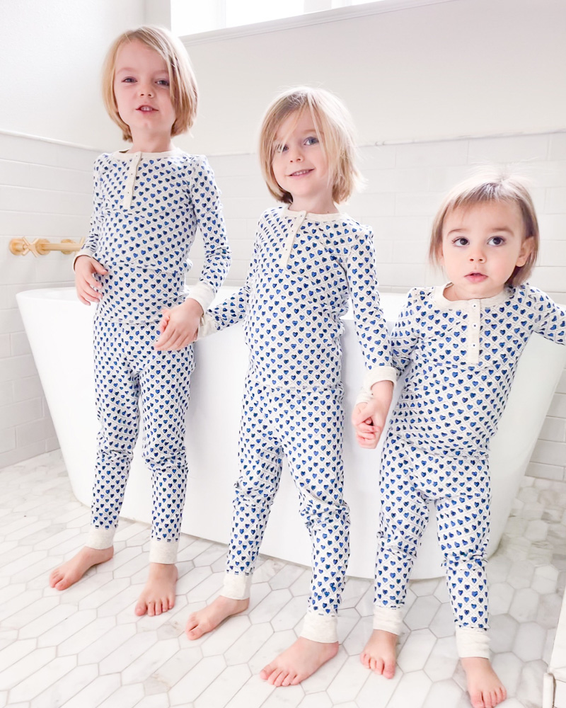 three preschool brothers in matching pajamas