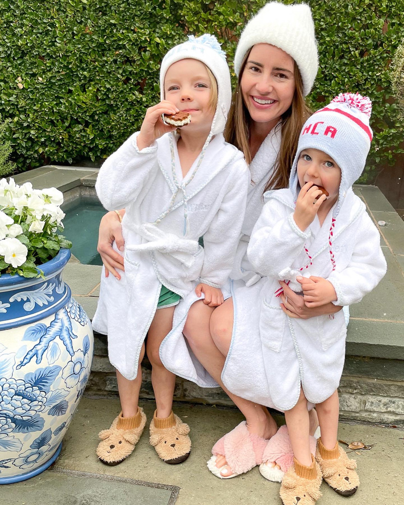 mom with two preschool sons in bathrobes by hot tub