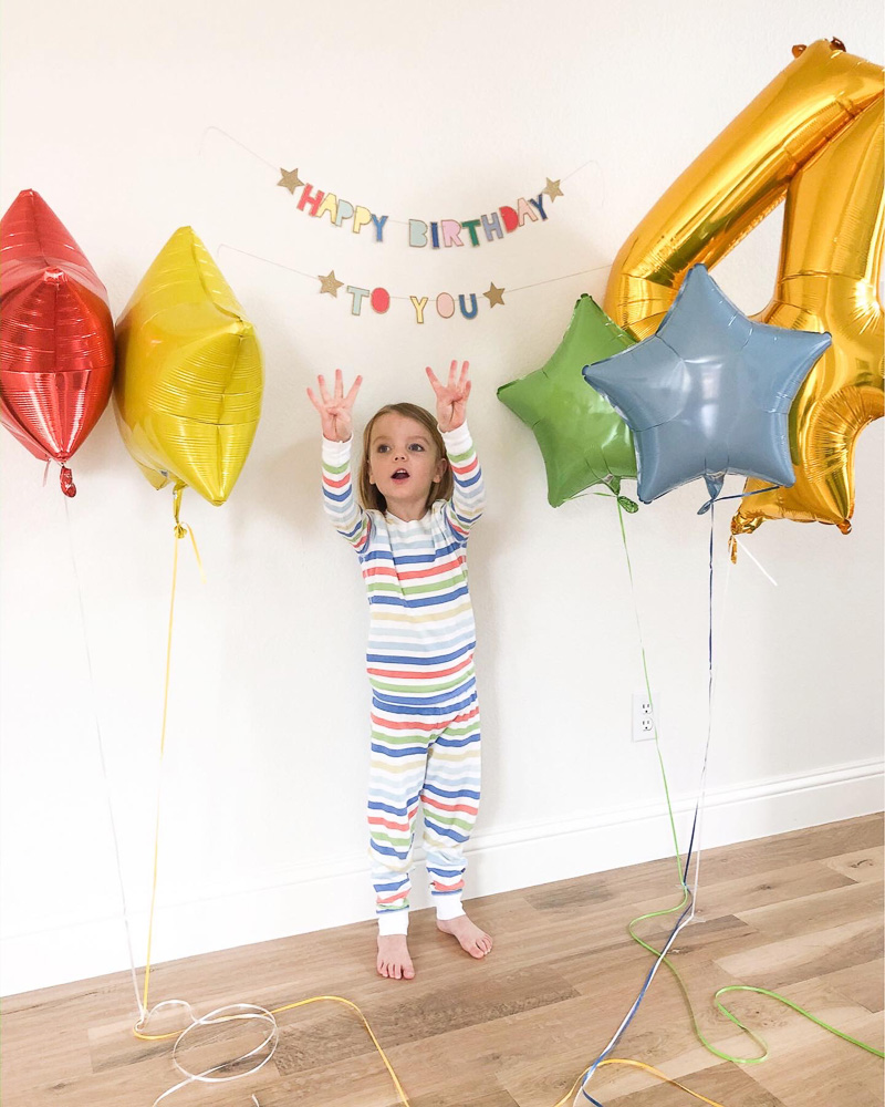 toddle boy with birthday balloons