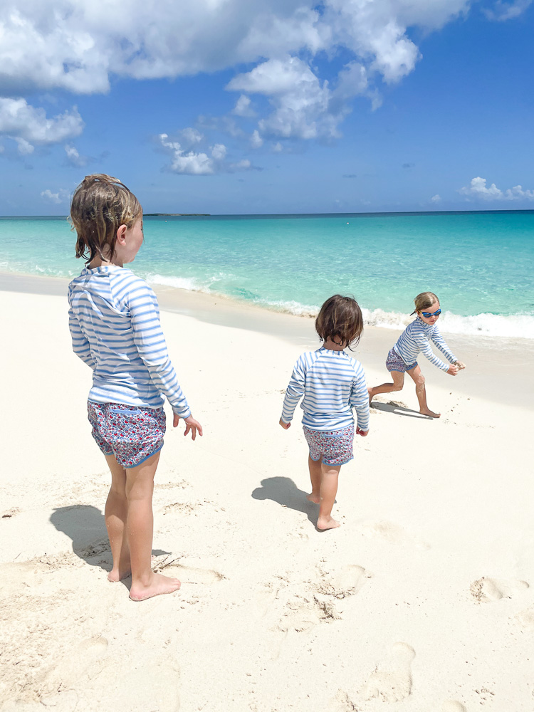 three toddler brothers playing in the sand bahamas beach