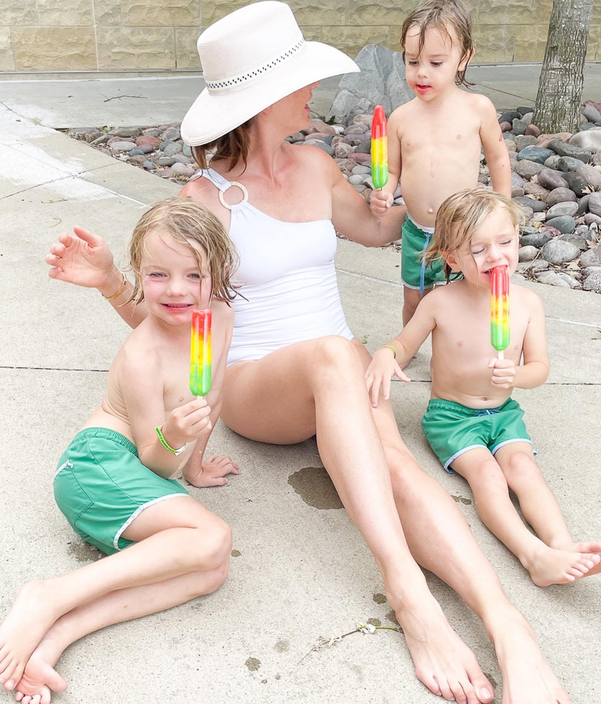mom with three toddler boys eating popsicles