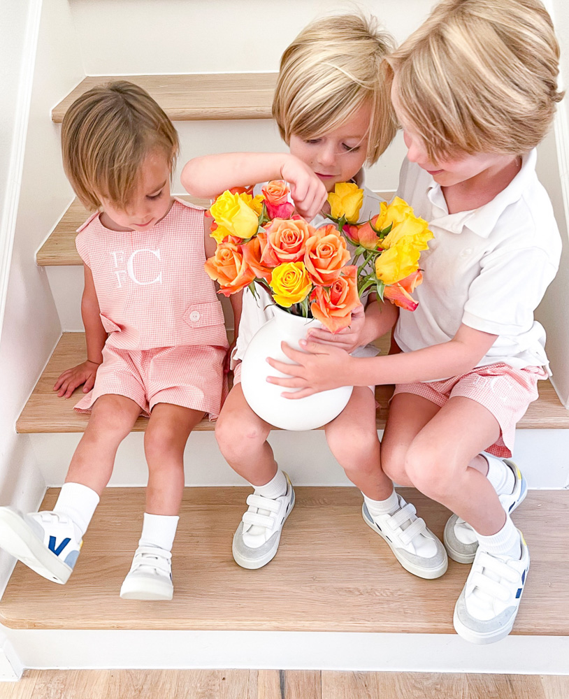 three little brothers with bouquet of flowers