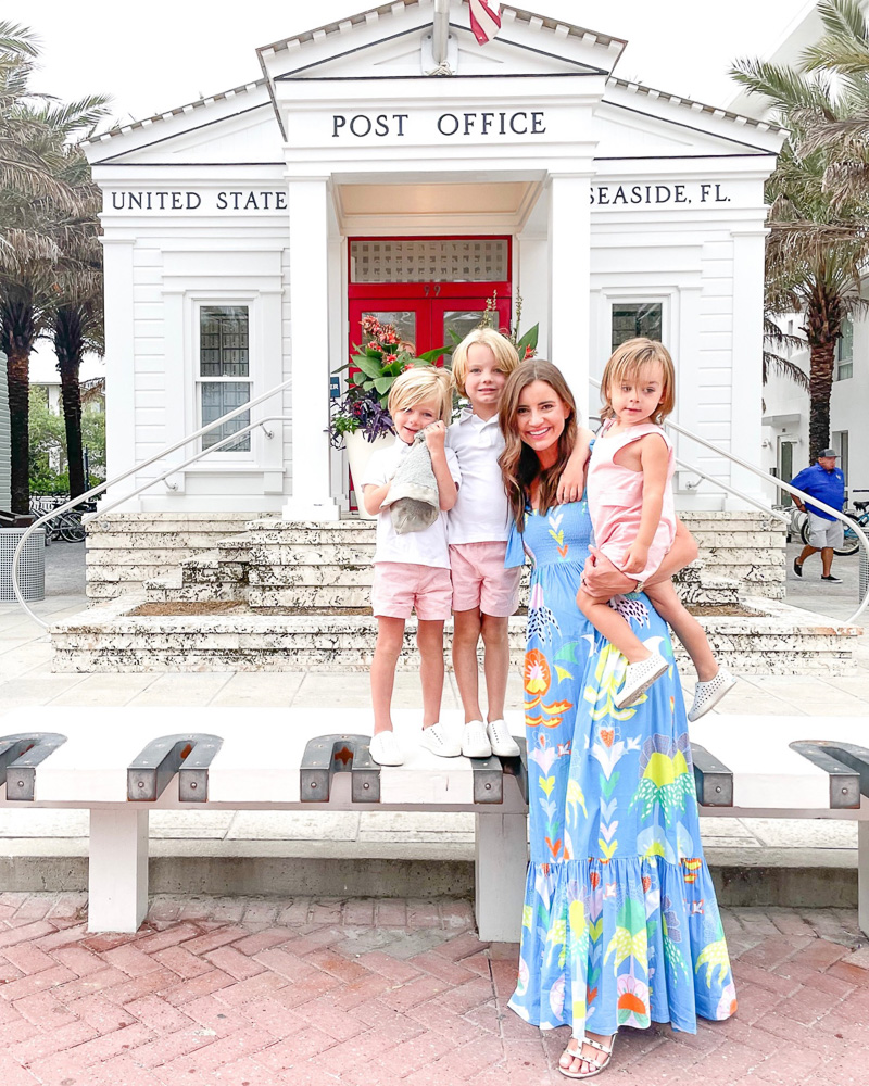 mom with three little boys standing in front of old post office in seaside fl