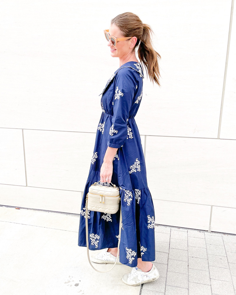 woman wearing navy embroidered floral maxi dress