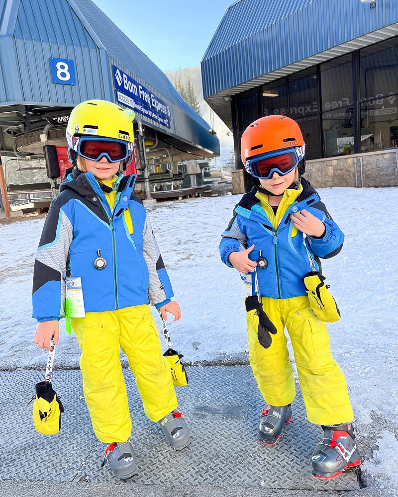 two toddler boys in ski gear