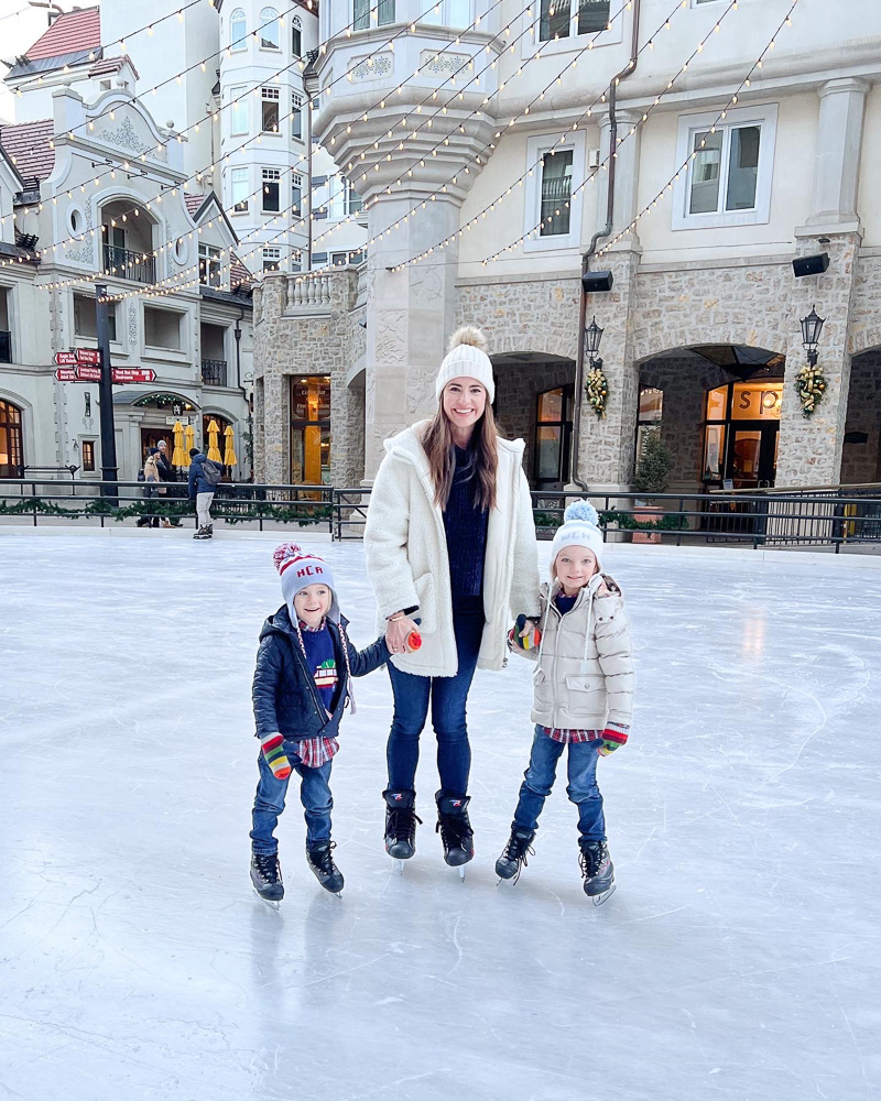 woman with two little boys ice skating